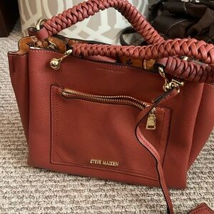Steve Madden purse with long strap
Not orange very much a fall burnt orange